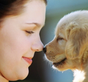 Woman Rubbing Noses with Puppy ca. 2002