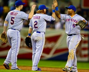 Mets players high-five one another after completing a Queens-Bronx sweep of the Yankees in this year's Subway Series.