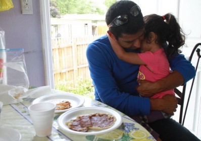 Luis Fuentes (L.) holds daughter, Janie. Fuentes is on an self-fueled investigation to find his wife.